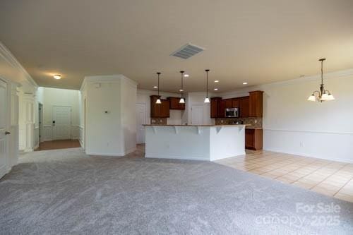 159 Saye Pl, Mooresville, NC 28115 - unfurnished living room featuring ornamental molding, light carpet, light tile patterned floors, a chandelier, and recessed lighting