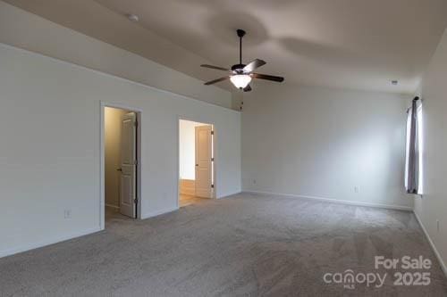 159 Saye Pl, Mooresville, NC 28115 - unfurnished bedroom with carpet, vaulted ceiling, connected bathroom, and ceiling fan