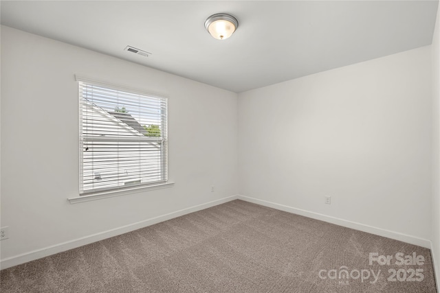 spare room with carpet flooring and baseboards