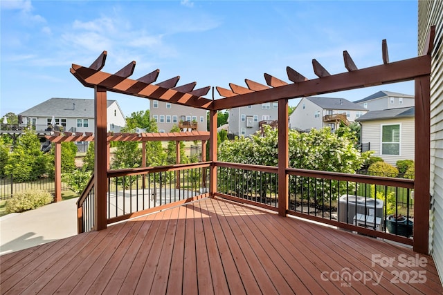 deck with a pergola and a residential view