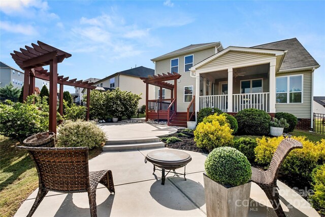 rear view of house with a pergola, a patio, a ceiling fan, a wooden deck, and a shingled roof