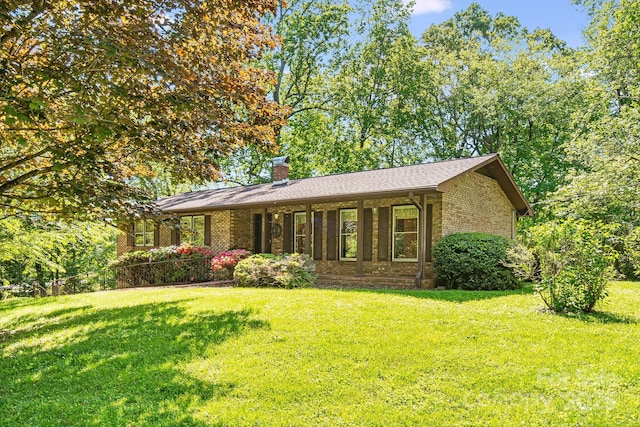 3127 Butler Bridge Rd, Mills River, NC 28759 - ranch-style home featuring brick siding, a front lawn, and a chimney