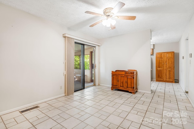 3127 Butler Bridge Rd, Mills River, NC 28759 - empty room with a textured ceiling, a ceiling fan, baseboards, and light tile patterned floors