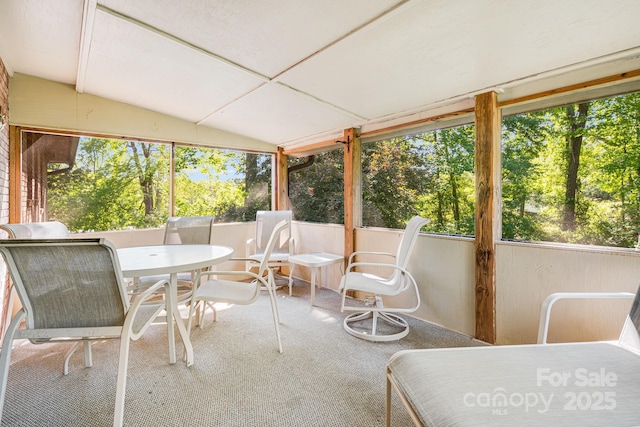 3127 Butler Bridge Rd, Mills River, NC 28759 - sunroom / solarium featuring healthy amount of natural light, outdoor dining area, lofted ceiling, and view of wooded area