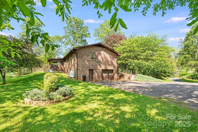 3127 Butler Bridge Rd, Mills River, NC 28759 - view of home's exterior with driveway, brick siding, and an attached garage