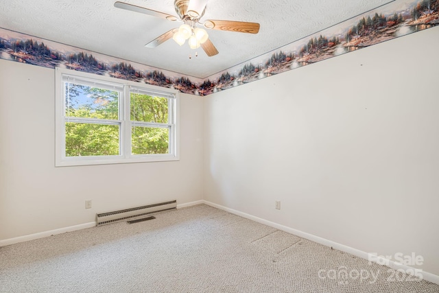 3127 Butler Bridge Rd, Mills River, NC 28759 - carpeted spare room with a baseboard heating unit, baseboards, a textured ceiling, and a ceiling fan