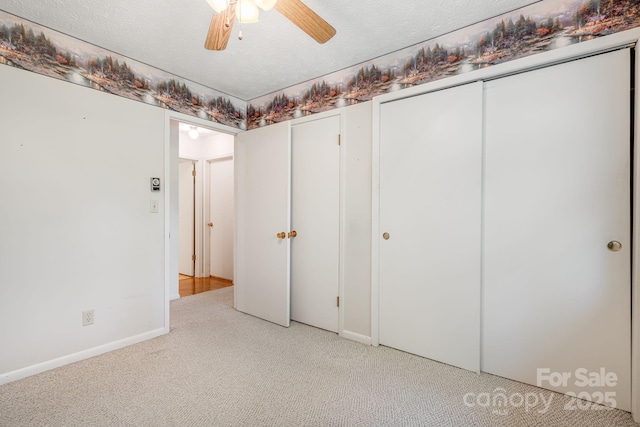 3127 Butler Bridge Rd, Mills River, NC 28759 - unfurnished bedroom with light carpet, baseboards, two closets, and ceiling fan
