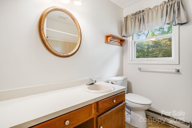 3127 Butler Bridge Rd, Mills River, NC 28759 - bathroom with a baseboard heating unit, toilet, and vanity