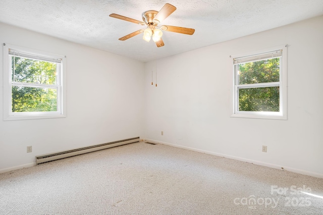 3127 Butler Bridge Rd, Mills River, NC 28759 - carpeted empty room featuring a baseboard heating unit, healthy amount of natural light, a textured ceiling, baseboards, and ceiling fan