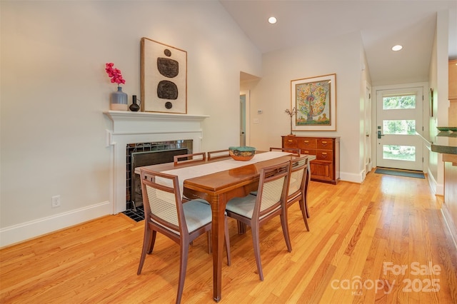 47 Lakeview Rd, Asheville, NC 28804 - dining space with a fireplace with flush hearth, baseboards, light wood-style floors, recessed lighting, and vaulted ceiling