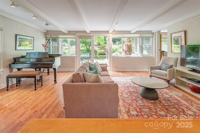 47 Lakeview Rd, Asheville, NC 28804 - living area featuring beamed ceiling, plenty of natural light, wood finished floors, and brick wall