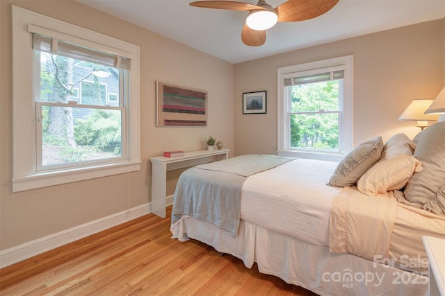47 Lakeview Rd, Asheville, NC 28804 - bedroom featuring multiple windows, light wood-type flooring, baseboards, and ceiling fan