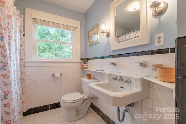 47 Lakeview Rd, Asheville, NC 28804 - full bathroom with tile walls, toilet, tile patterned floors, wainscoting, and a sink