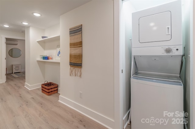 47 Lakeview Rd, Asheville, NC 28804 - laundry area featuring estacked washer and dryer, an AC wall unit, light wood-style floors, baseboards, and recessed lighting