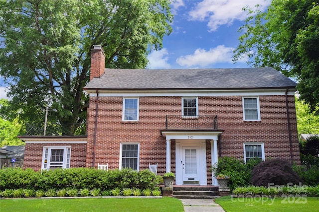 1101 Pee Dee Ave, Albemarle, NC 28001 - view of front of property with a chimney, brick siding, a front lawn, and roof with shingles