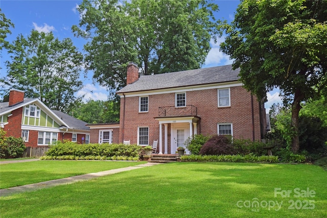 1101 Pee Dee Ave, Albemarle, NC 28001 - view of front of house with brick siding, a front yard, and a chimney