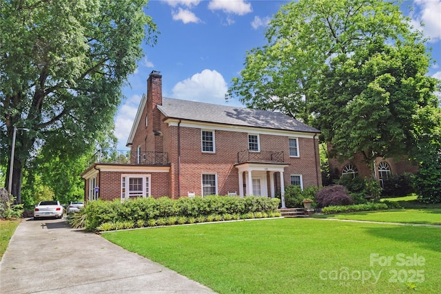 1101 Pee Dee Ave, Albemarle, NC 28001 - colonial inspired home featuring brick siding, a front yard, a chimney, and concrete driveway