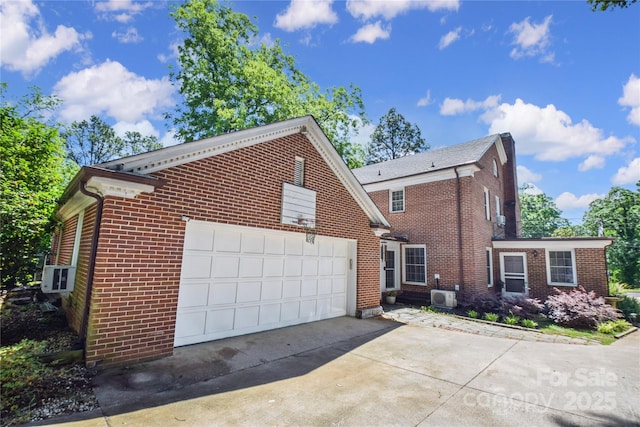 1101 Pee Dee Ave, Albemarle, NC 28001 - view of home's exterior featuring brick siding, driveway, central AC, and a garage