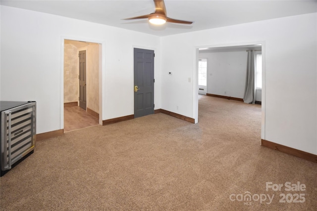1101 Pee Dee Ave, Albemarle, NC 28001 - carpeted spare room with wine cooler, a ceiling fan, and baseboards