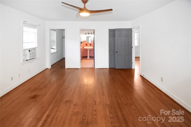 1101 Pee Dee Ave, Albemarle, NC 28001 - unfurnished bedroom featuring multiple windows, wood finished floors, and baseboards