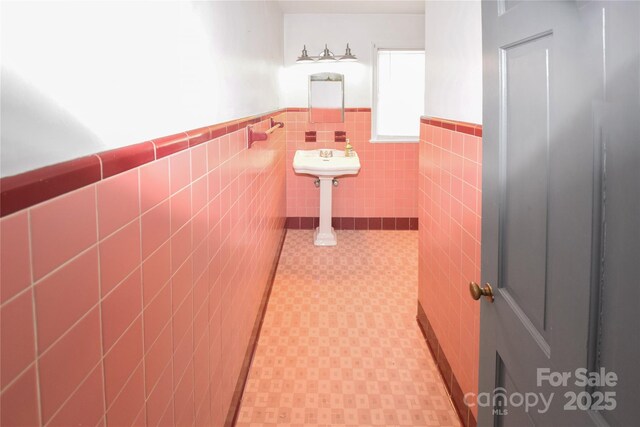 1101 Pee Dee Ave, Albemarle, NC 28001 - corridor featuring wainscoting, light flooring, and tile walls