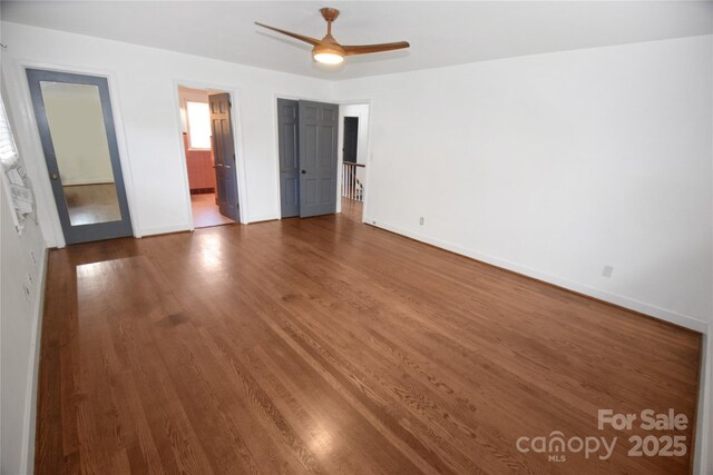 1101 Pee Dee Ave, Albemarle, NC 28001 - unfurnished bedroom with baseboards, wood finished floors, ensuite bathroom, and ceiling fan