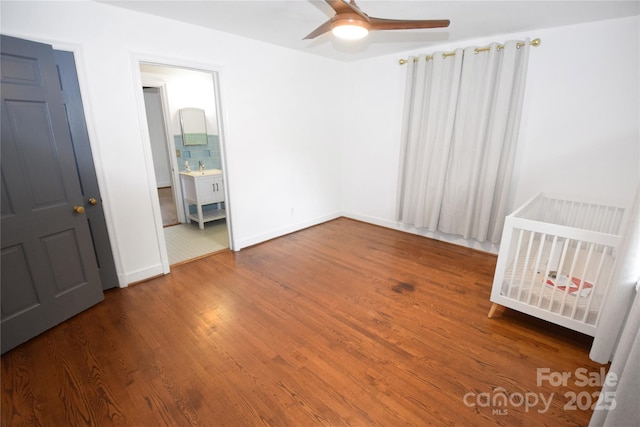 1101 Pee Dee Ave, Albemarle, NC 28001 - unfurnished bedroom featuring wood finished floors, baseboards, and ceiling fan