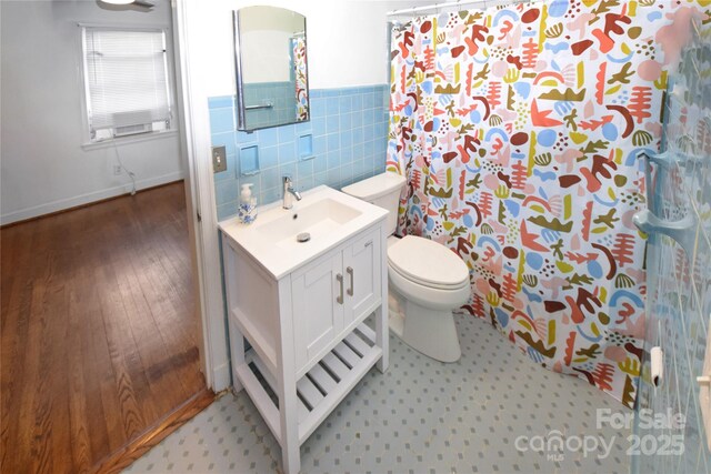 1101 Pee Dee Ave, Albemarle, NC 28001 - full bath featuring toilet, vanity, tile walls, a shower with curtain, and wood finished floors