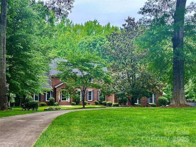 7103 Forest Ridge Rd, Matthews, NC 28104 - obstructed view of property featuring a front lawn and brick siding