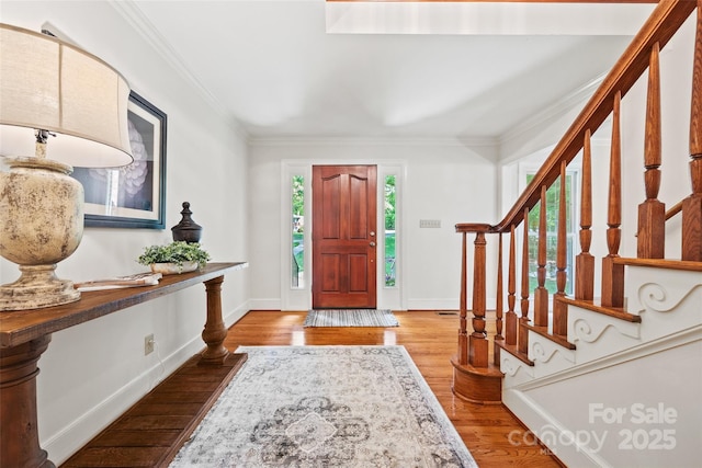 7103 Forest Ridge Rd, Matthews, NC 28104 - foyer with ornamental molding, stairs, wood finished floors, and baseboards