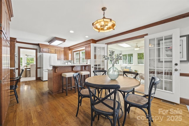 7103 Forest Ridge Rd, Matthews, NC 28104 - dining room featuring a ceiling fan, plenty of natural light, ornamental molding, wood finished floors, and recessed lighting