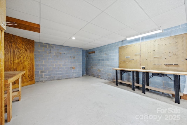 7103 Forest Ridge Rd, Matthews, NC 28104 - basement featuring a workshop area, concrete block wall, and a drop ceiling