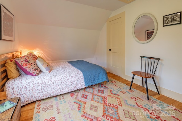 564 Jupiter Rd, Weaverville, NC 28787 - bedroom featuring wood finished floors, vaulted ceiling, and baseboards