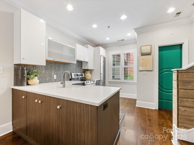 kitchen with appliances with stainless steel finishes, baseboards, ornamental molding, white cabinets, and light countertops