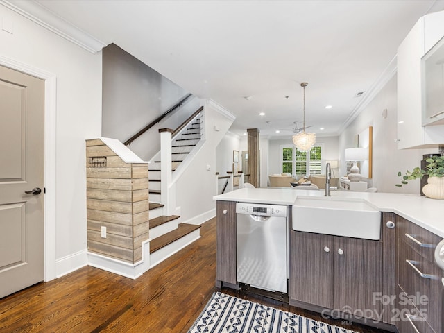 kitchen with dishwasher, a sink, crown molding, dark wood-type flooring, and a peninsula