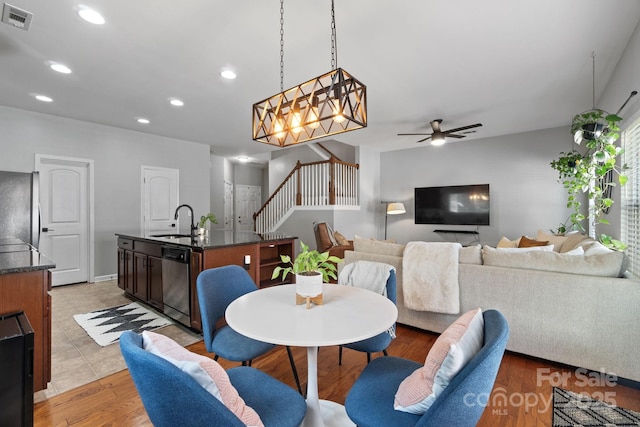 dining area featuring recessed lighting, stairway, ceiling fan, and light wood finished floors