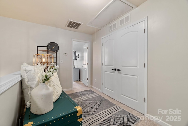 entrance foyer featuring light colored carpet and baseboards