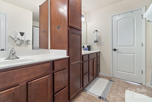 full bathroom featuring tile patterned floors, vanity, and baseboards