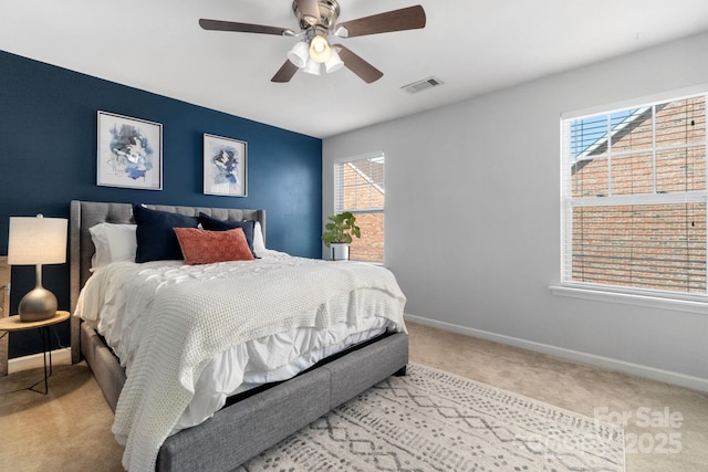 bedroom with carpet floors, multiple windows, baseboards, and a ceiling fan