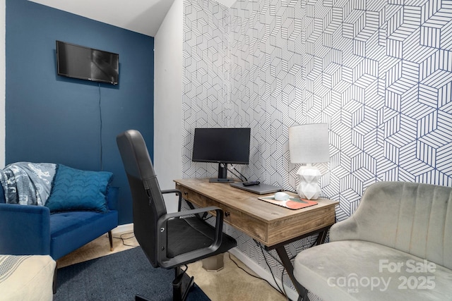home office featuring an accent wall and carpet flooring