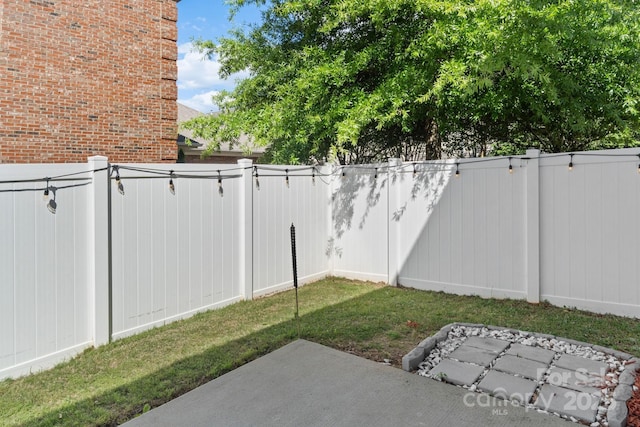 view of yard featuring fence and a patio area