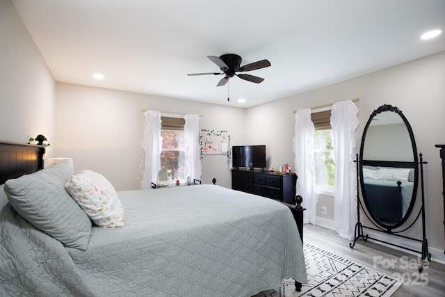 bedroom with light wood-type flooring, baseboards, and recessed lighting