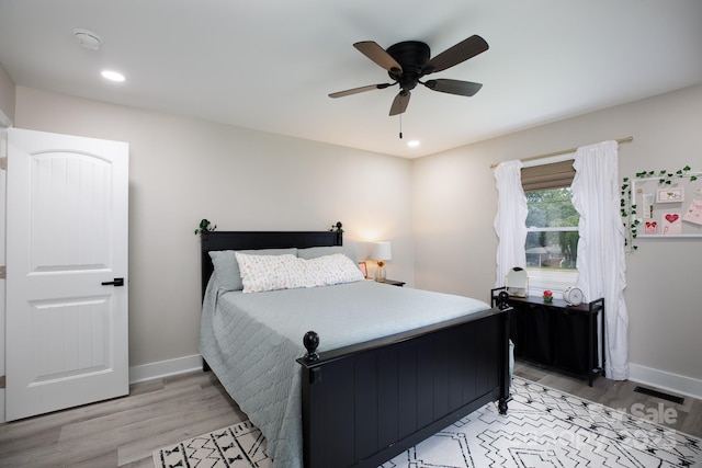 bedroom featuring baseboards, light wood-style floors, and recessed lighting