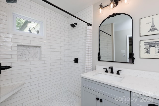 bathroom featuring vanity and a tile shower
