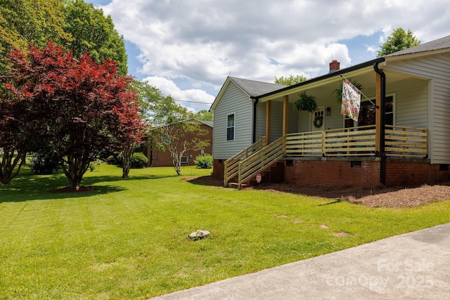 view of side of home with covered porch, roof with shingles, crawl space, a yard, and a chimney