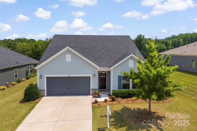 5727 Lavaux Ct, Charlotte, NC 28214 - view of front of property featuring concrete driveway, an attached garage, a front yard, and a shingled roof