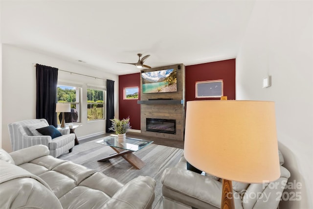 5727 Lavaux Ct, Charlotte, NC 28214 - living area featuring a glass covered fireplace, wood finished floors, and baseboards