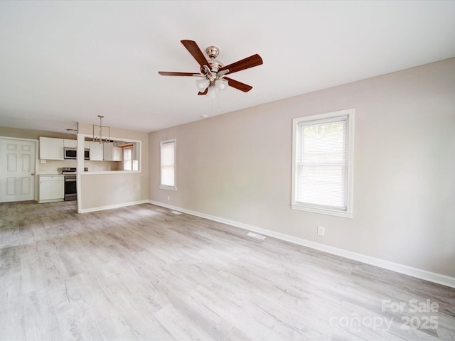 unfurnished living room featuring ceiling fan, baseboards, and light wood-type flooring
