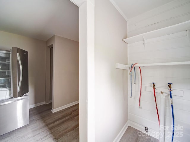 washroom featuring wood finished floors and baseboards