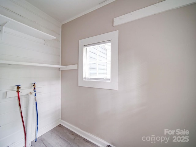 washroom featuring light wood finished floors, baseboards, ornamental molding, and hookup for a washing machine